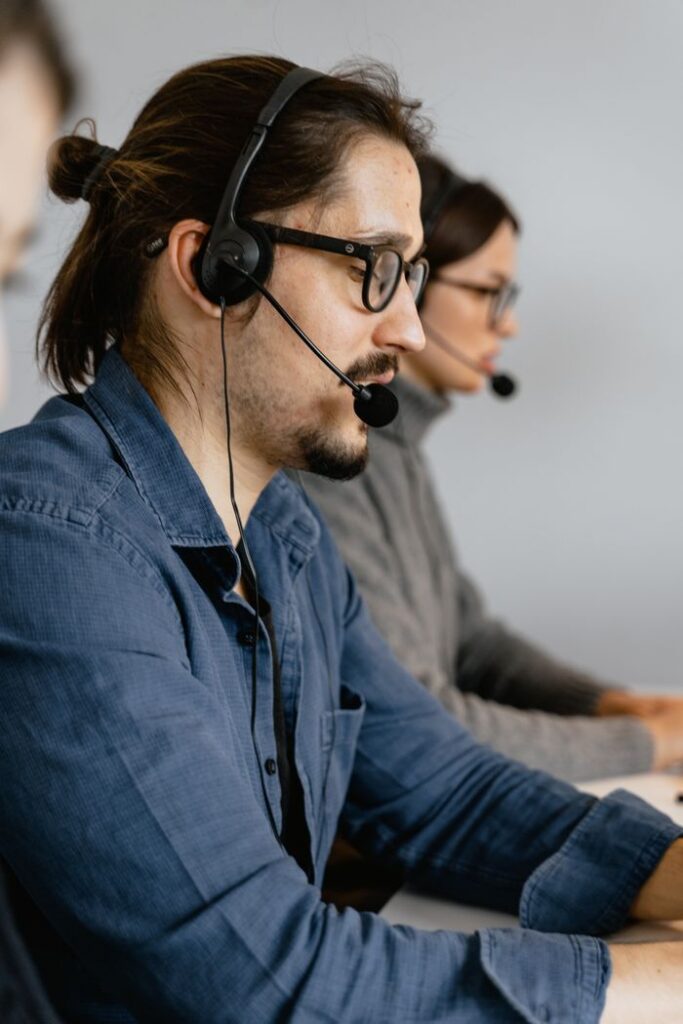 Crafting Captivating Headlines: Your awesome post title goes here Call center agents focused on assisting customers using headsets in a modern office.